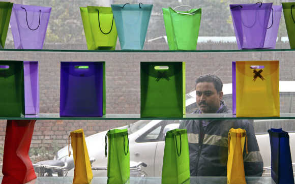 A man looks at poly-bags on display outside a factory at Ludhiana.