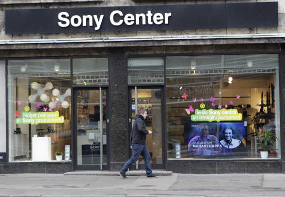 A man walks past Sony shop in Riga, Latvia.
