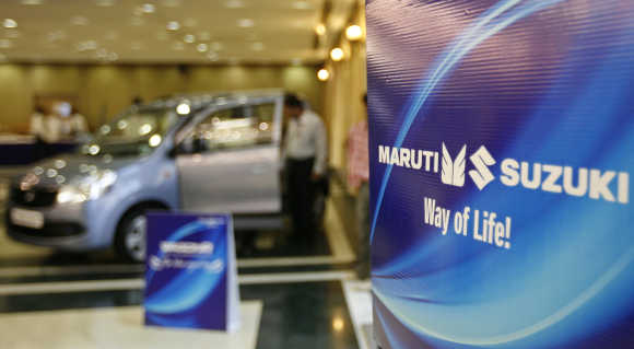 A customer stands inside a Maruti Suzuki's car showroom in Ahmedabad.