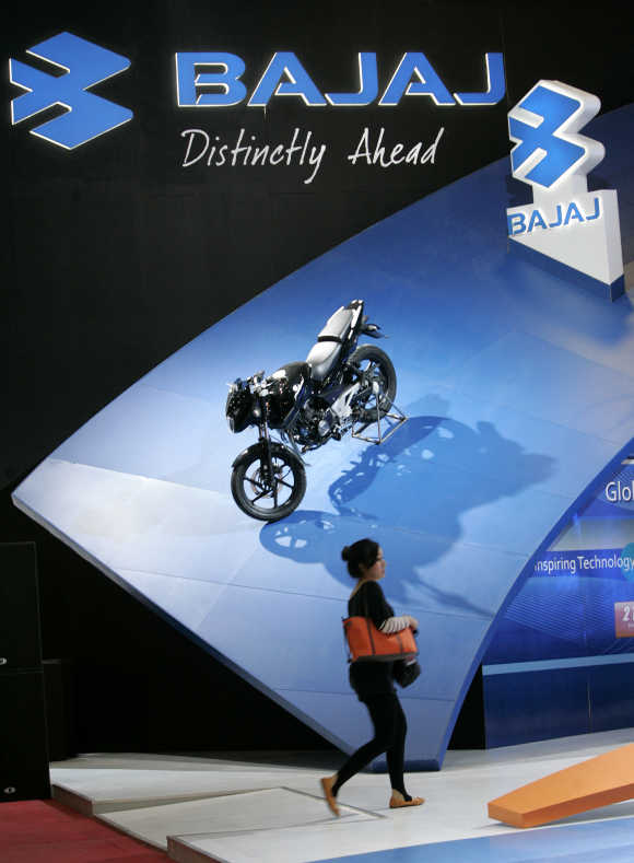 A visitor walks past a Bajaj motorcycle during the Jakarta Motor Show.