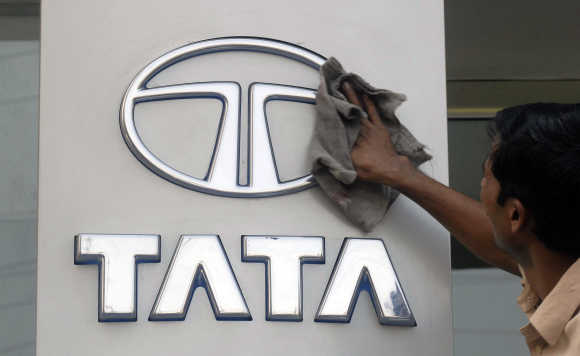 A worker cleans a Tata Motors logo in Hyderabad.