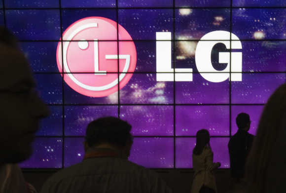 Showgoers walk past a display at the LG Electronics booth during the 2012 International Consumer Electronics Show in Las Vegas.
