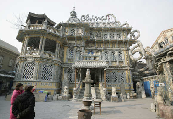 Visitors look at the 'China House' in Tianjin. The house is decorated with hundreds of millions of ancient porcelain flakes, ancient bowls, dishes and vases, inlaid everywhere in the architecture.