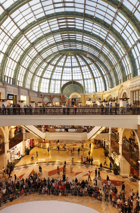 People stand near the fashion dome in Mall of the Emirates, Dubai.