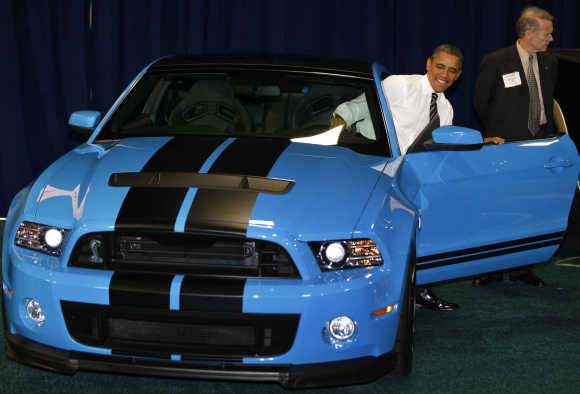 US President Barack Obama sits in a Ford Mustang Shelby GT-500 at the 2012 Washington Auto Show at the Walter E Washington Convention Center in Washington.