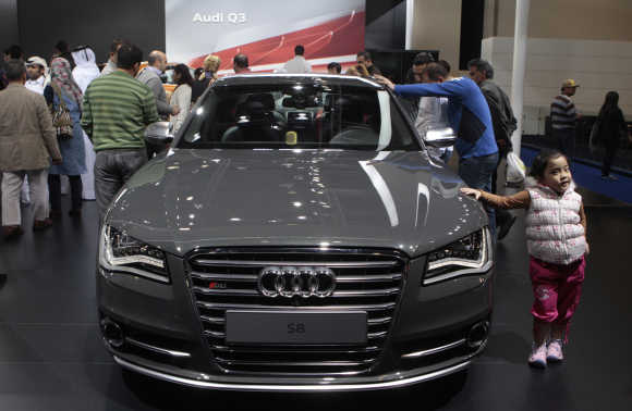 Visitor look on at the Audi S8 at the Qatar International Motor Show in Doha.