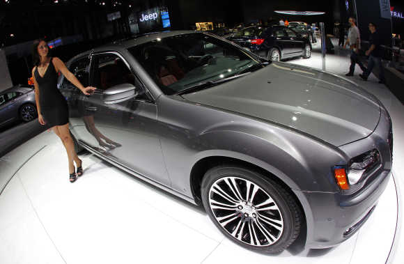 Model next to Chrysler 300 S on display at New York International Auto Show.