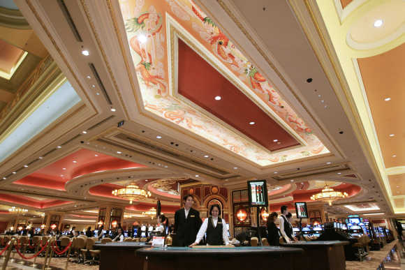 Employees stand by in the casino at the Venetian in Macau.