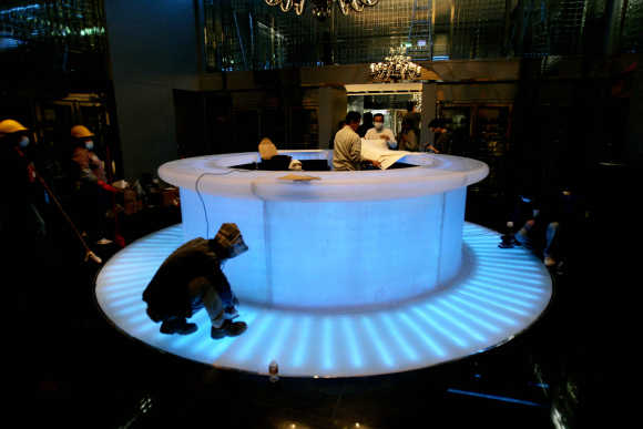 Workers put on the last touches to a restaurant in the MGM Grand Macau hotel in Macau.