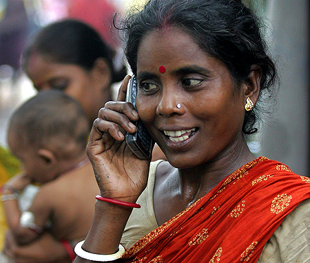 Tulsi Prasad, an Indian slum dweller, uses a mobile phone in Kolkata.