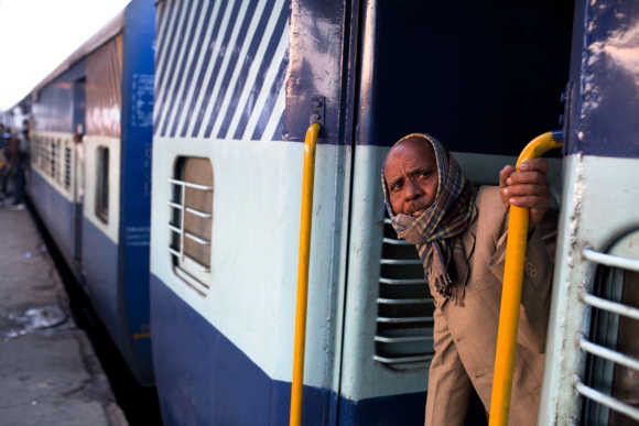 A man peers from a carriage prior to departure from the Nizamuddin Railway Station.