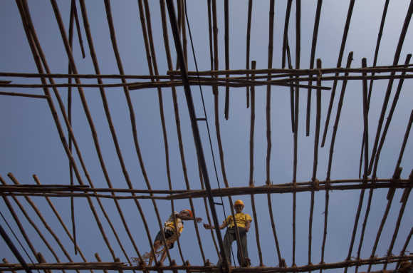 Labourers work on erecting bamboo scaffolding at a construction site in Mumbai. Photo is for representation purpose only.