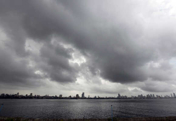 A man sits on a seafront against the backdrop of monsoon clouds in Mumbai. Photo is for representation purpose only.