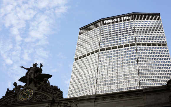 A statue stands atop Grand Central Station in front of the MetLife building in New York.
