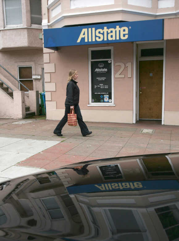 A pedestrian walks past Allstate insurance office in San Francisco.