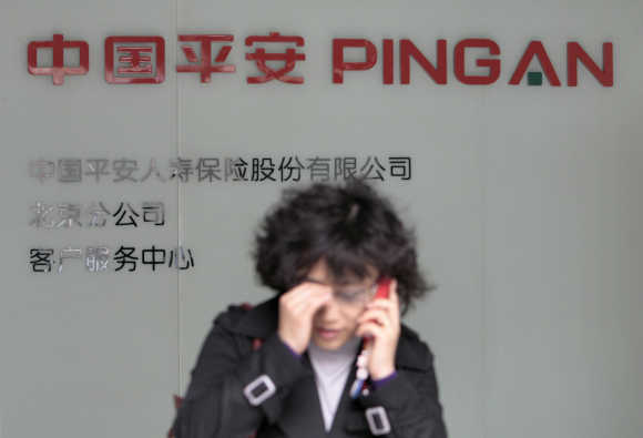 A woman talks on her mobile at a customer service centre of Ping An Insurance of China in Beijing.