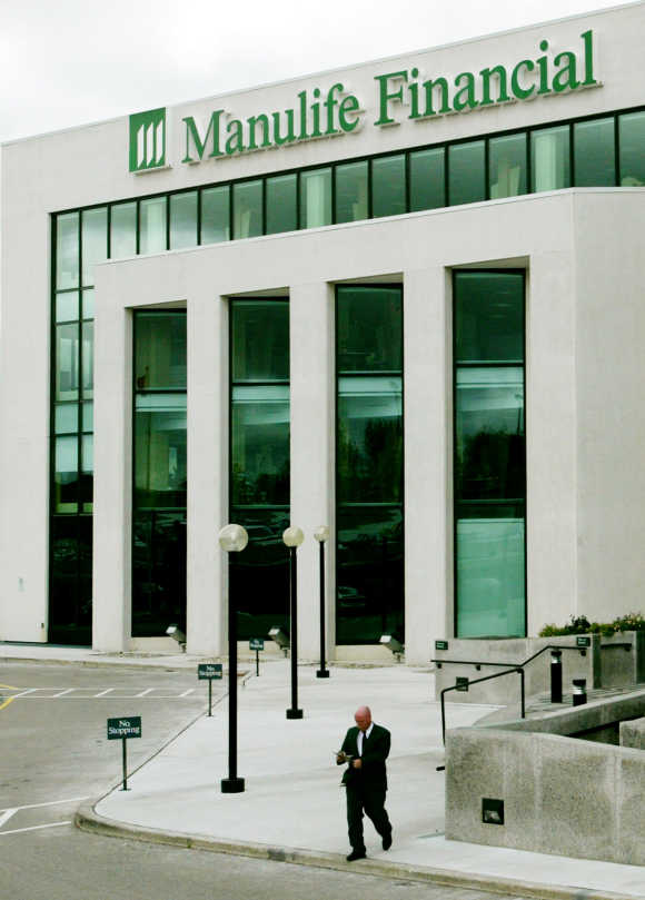 A man leaves the offices of Manulife Financial Corporation in Waterloo, Ontario.