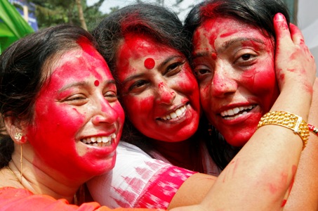 Women pose for a photo after smearing each other with vermillion powder as part of a ritual on the last day of the Durga Puja festival in Kolkata.
