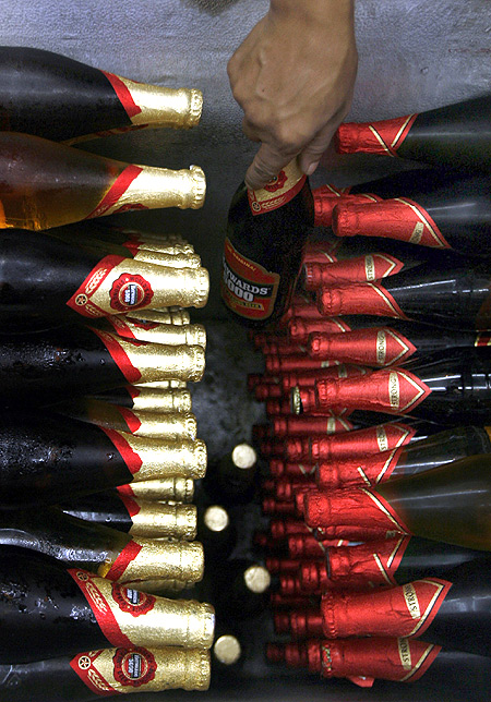 A man selects a bottle of beer inside a shop selling alcohol in Siliguri.