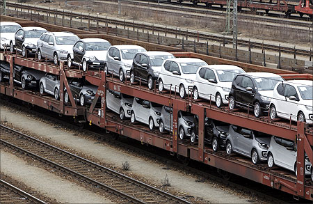 New cars by German car manufacturer Volkswagen AG stand on wagons at a train station in Munich.