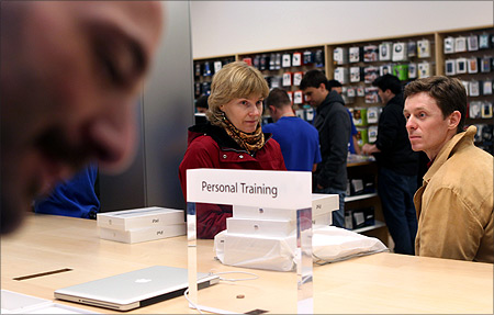 Customers wait for personal training after purchasing the new iPad at the Apple flagship retail store in San Francisco.