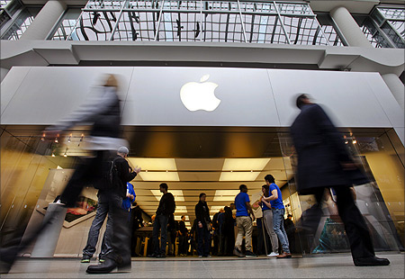 People walk by the Apple Store in the Eaton Centre shopping mall in Toronto.