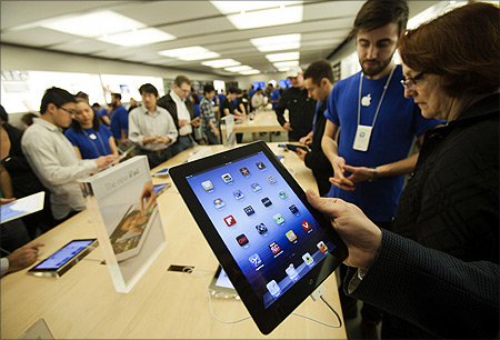 Customers look at the the new iPad at the Apple Store at the Toronto Eaton Centre shopping mall in Toronto.