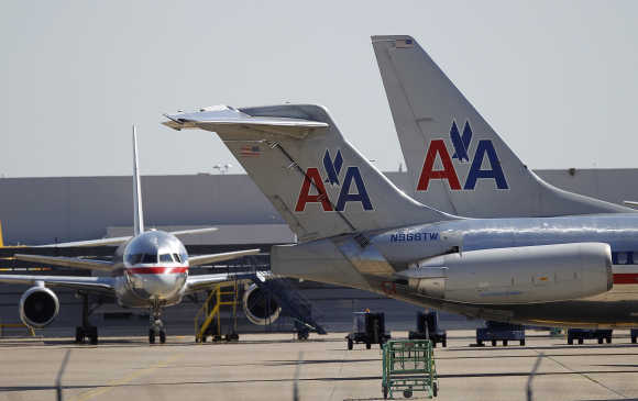 American Airlines airliners sit near a hanger at Dallas/Fort Worth International Airport, Texas.