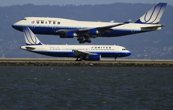 United Airlines planes take off and land at San Francisco airport.
