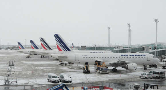 Air France planes are seen on the snow covered tarmac at the Charles-de-Gaulle airport in Roissy, near Paris.