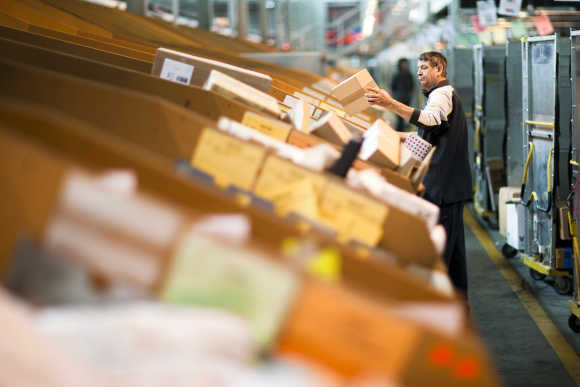 A Swiss postal employee sorts parcels in one of the three main Swiss logistic hubs in Daillens near Lausanne.