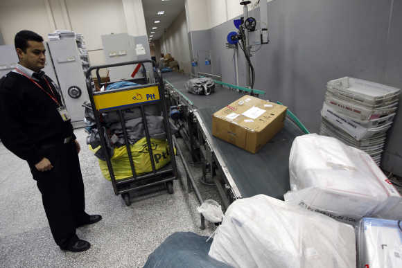 A security personal monitors incoming parcels in Turkish Post's postal logistic centre at the Ataturk International airport in Istanbul.