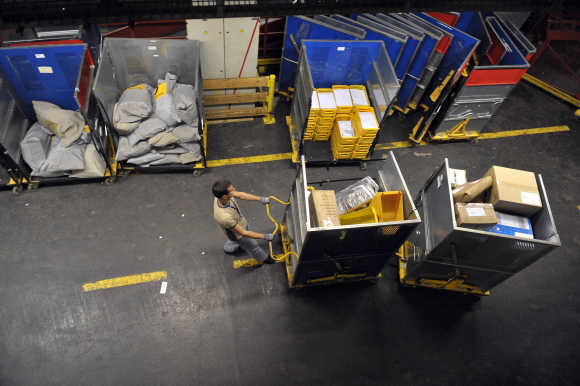 Worker deploys packages in logistic centre in Ljubljana.