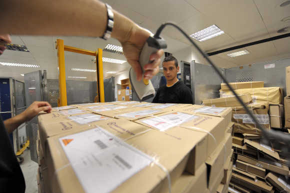 A worker deploys packages in logistic centre in Ljubljana.