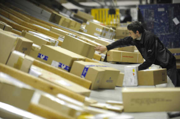 A worker deploys packages in postal logistic centre in Ljubljana.