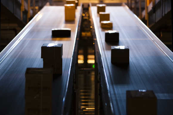 Parcels travel on a conveyer belt before being sorted for delivery in Daillens near Lausanne.