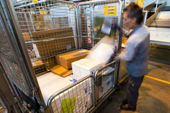A Swiss post employee sorts parcels in Daillens near Lausanne.