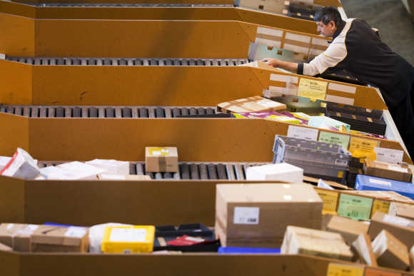 A Swiss post employee sots parcels in in Daillens near Lausanne.