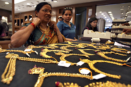 A customer tries on a gold necklace inside a jewellery showroom in the southern Indian city of Hyderabad.