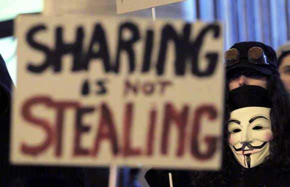 A protester wearing a Guy Fawkes mask, symbolic of the hacktivist group 'Anonymous', takes part in a protest in central Brussels.