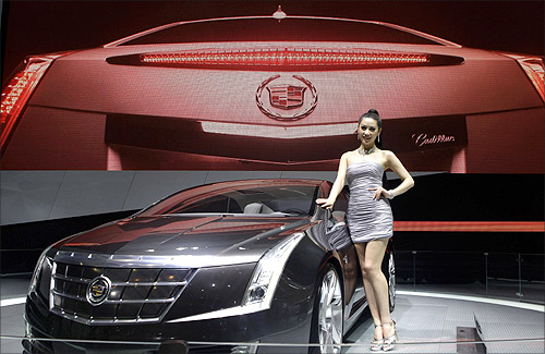 A model stands next to a Cadillac ELR at Auto China 2012 in Beijing April 24, 2012.