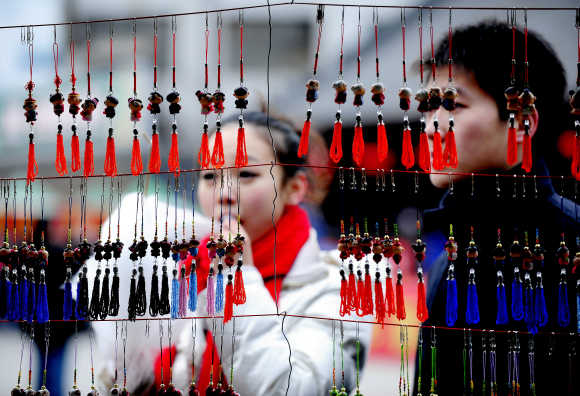 People shop during the Lunar New Year of the Rabbit in Shenyang, Liaoning Province of China.