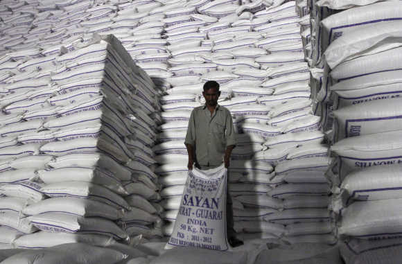A worker shifts a sack of sugar at a godown inside a sugar factory at Sanyan village in Gujarat.