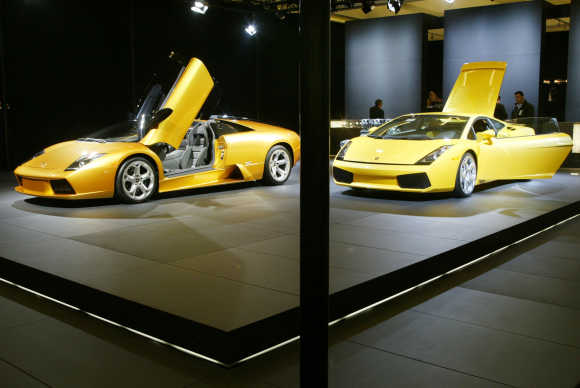Lamborghini Gallardo, right, and the Murcielago roadster, left, stand on display at the Los Angeles Auto Show.