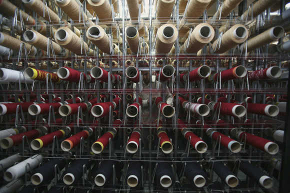 An employee works inside a carpet manufacturing industry on the outskirts in Jammu.