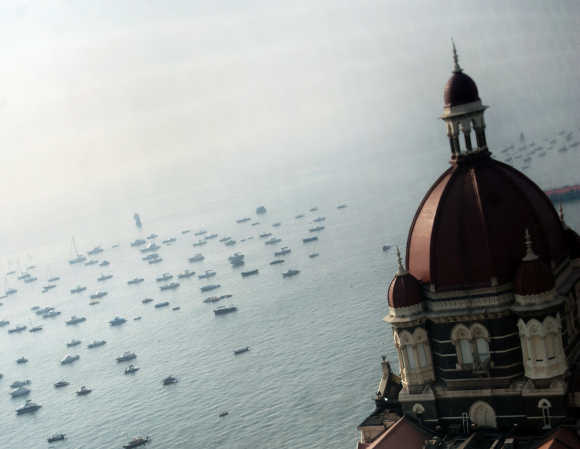 The domes of the Taj Mahal hotel are seen in front of the Arabian Sea in Mumbai.