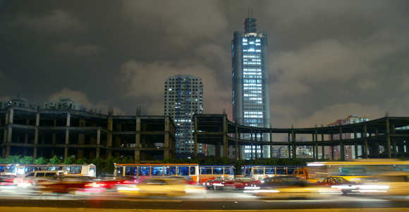 Vehicles travel in the main street during night time in Guangzhou.