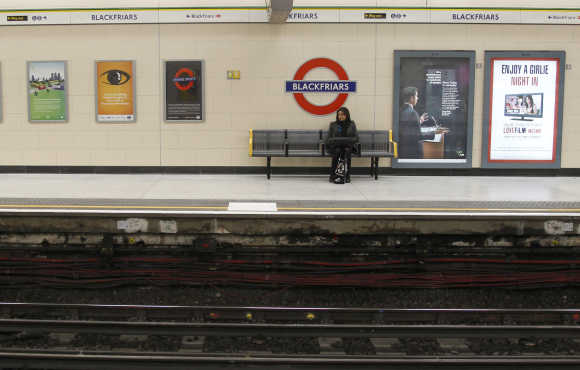 A passenger waits at Blackfriars London Underground station in London.