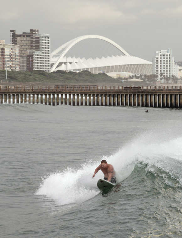 A knee boarder catches a wave on Durban's beach front.