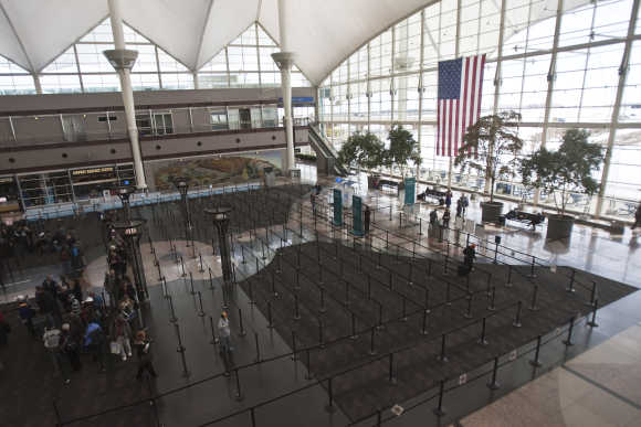 Passengers wait in security lines at the Denver International Airport.